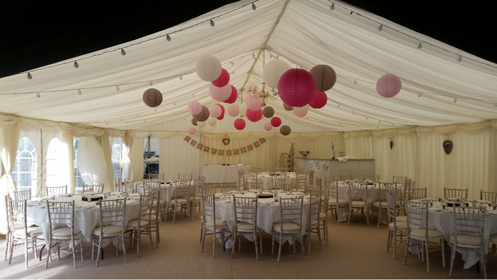 Latte and Pink Lanterns Decorate a Rustic Marquee