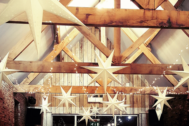 Star lanterns offer alternative barn wedding decoration